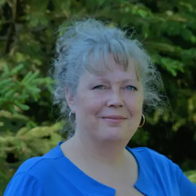 Christine in front of a tree